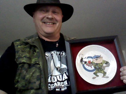 John Marlowe proudly holding his TAZ Plate