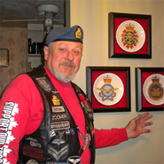Zoomer standing proudly with his collection of Canadian Forces Badge Plates